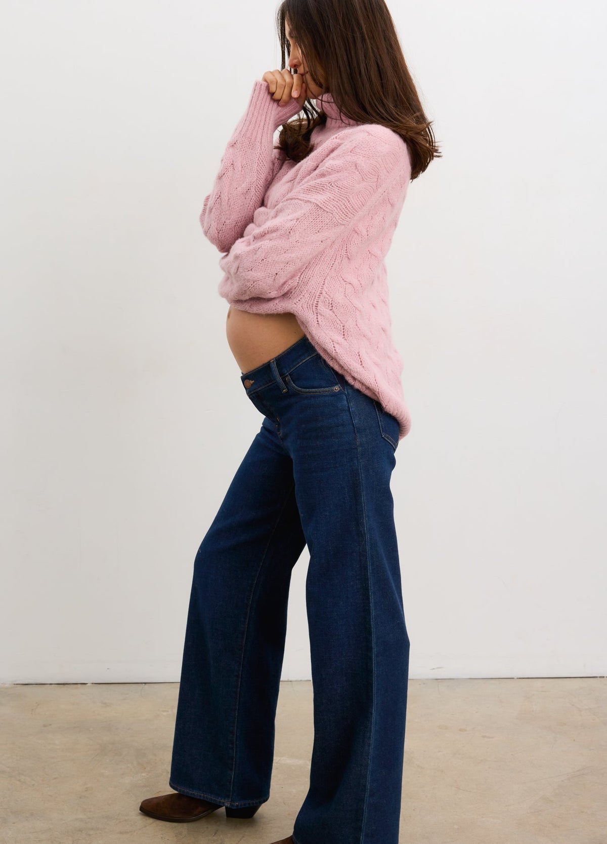 Lilac alpaca cable knit maternity turtleneck sweater on pregnant model with wide-leg jeans.