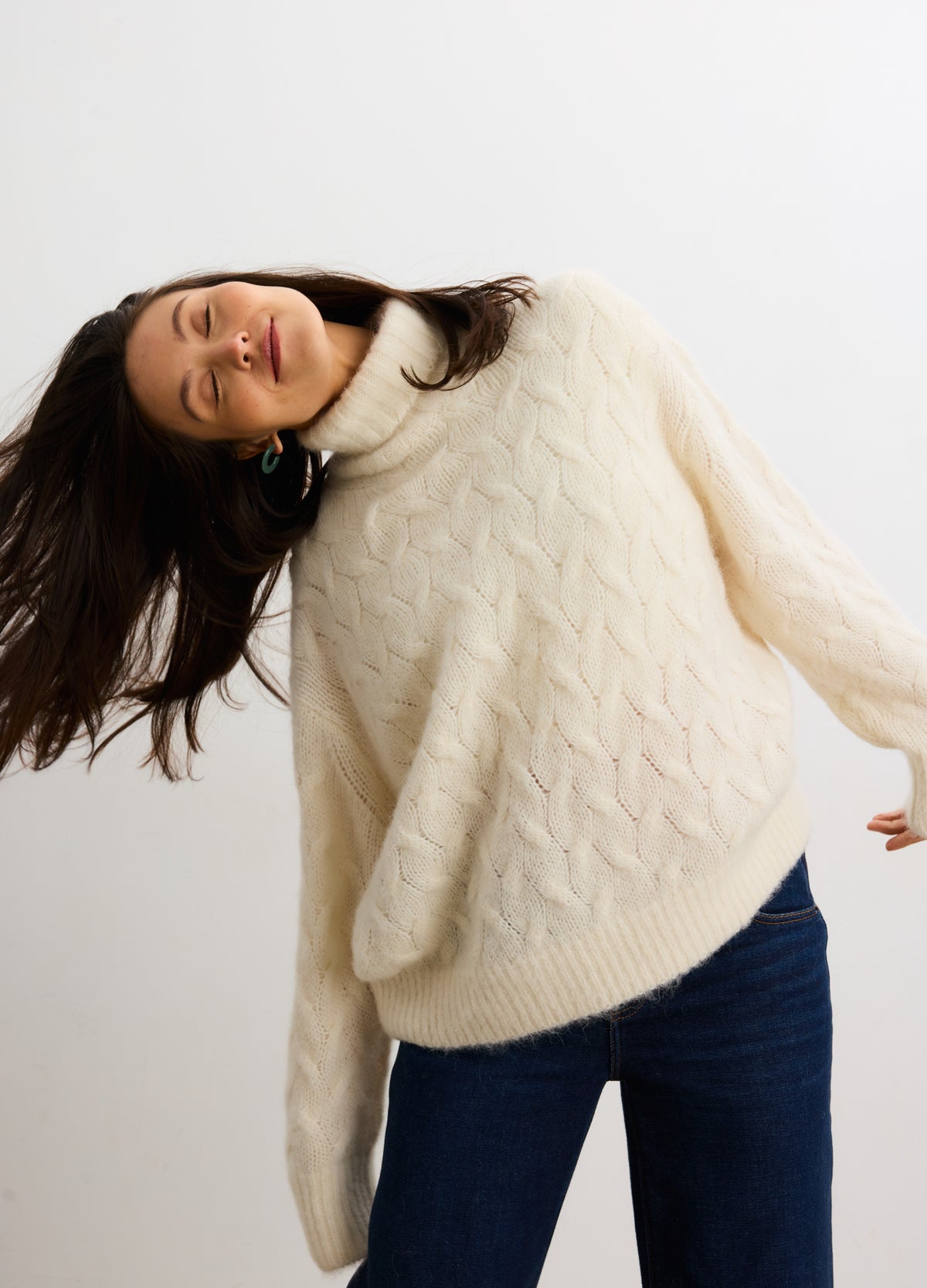 Ivory cable-knit alpaca turtleneck sweater designed for pregnant maternity wear with relaxed fit.