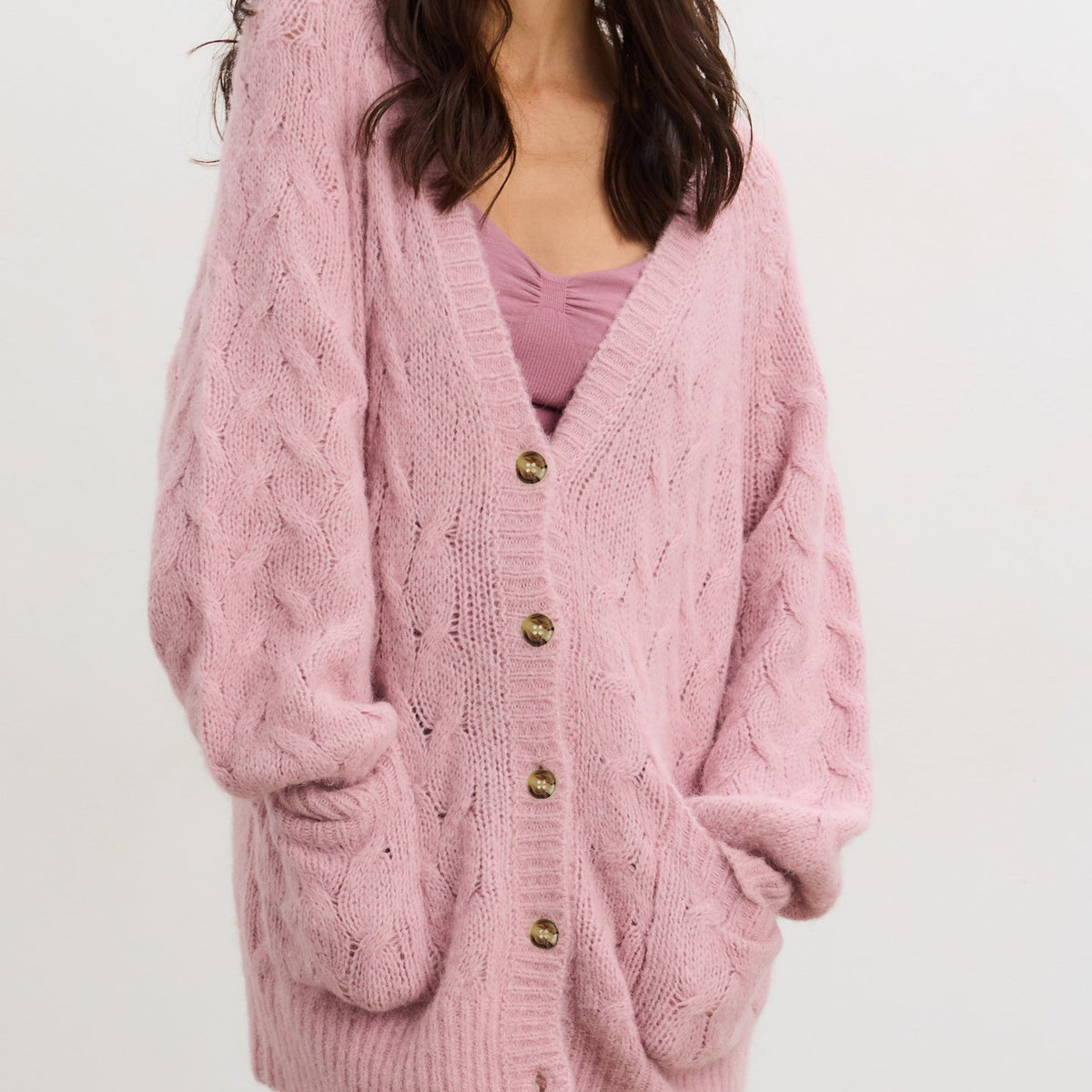 Lilac alpaca cable knit maternity cardigan with large buttons and front pockets, styled for pregnant wear.