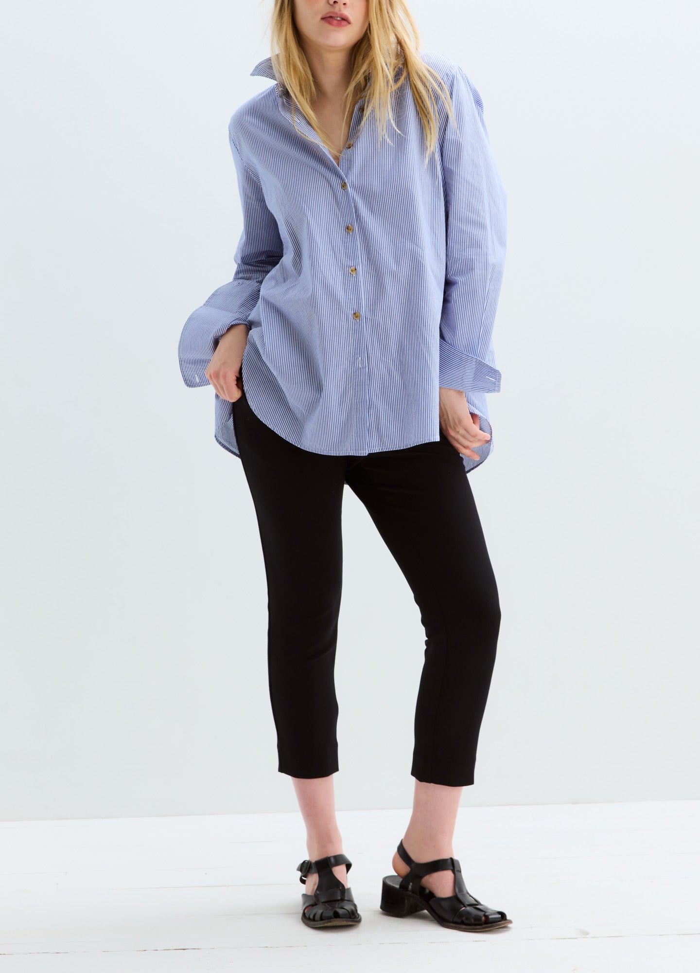 Light blue striped maternity buttondown shirt with long sleeves and relaxed fit.