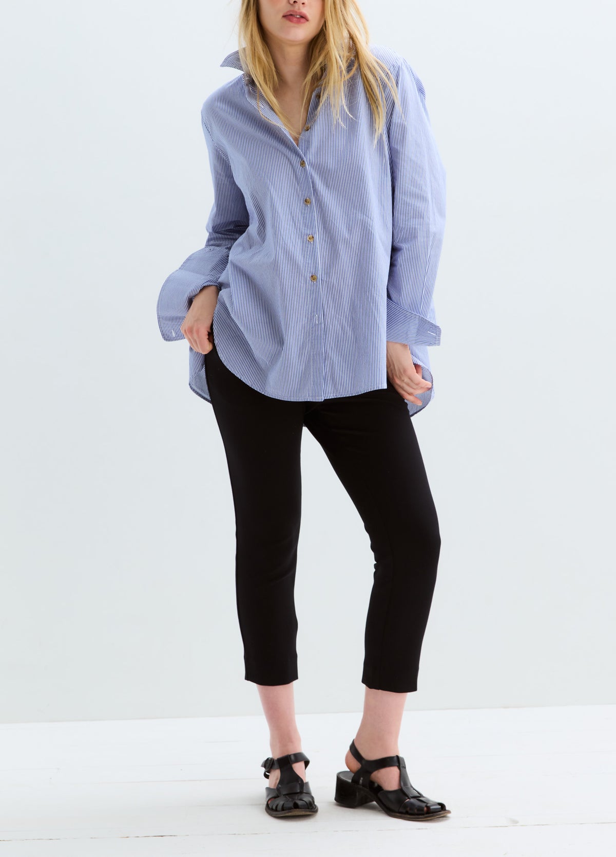 Light blue striped maternity buttondown shirt with long sleeves and relaxed fit.