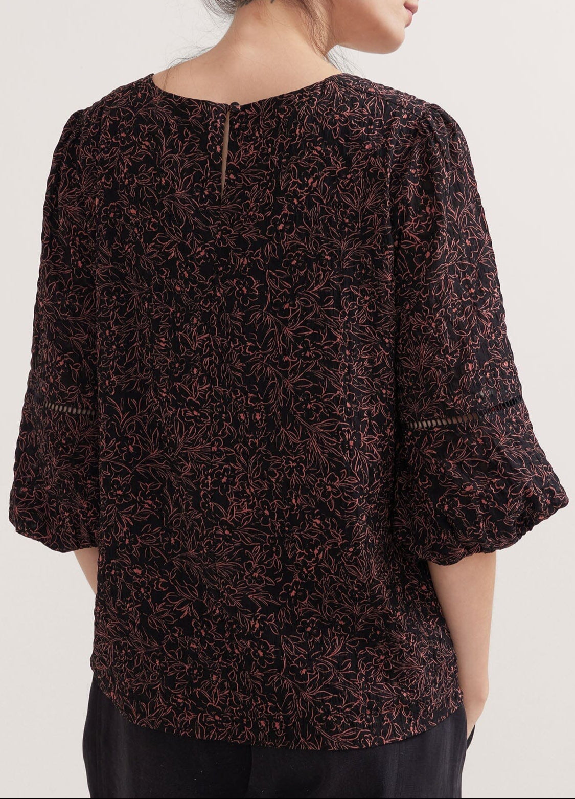 The Juliet Top - Black and pink floral maternity nursing top with V-neck and 3/4 puff sleeves, ruched sides for postpartum comfort.