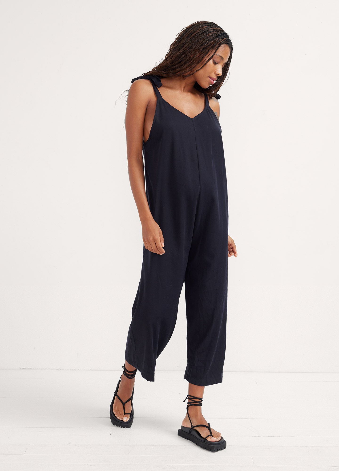 Black sleeveless maternity jumpsuit with relaxed fit and cropped wide legs.
