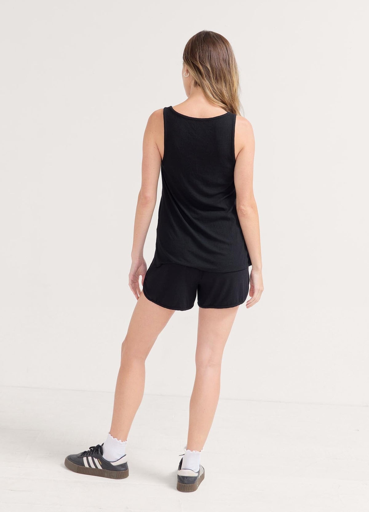 The Softest Rib Nursing Tank - Black ribbed nursing tank with scoop neckline and racerback, styled for maternity, pregnancy, and postpartum comfort.
