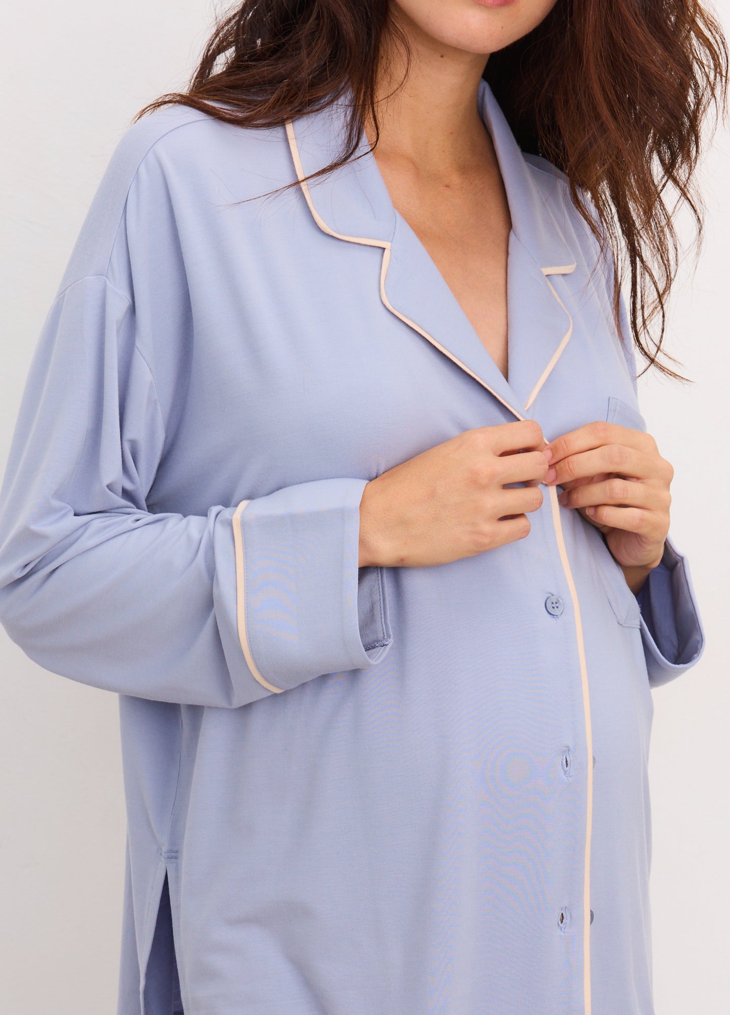 Light blue maternity pajama top with contrast white piping and button-down front, soft jersey fabric.