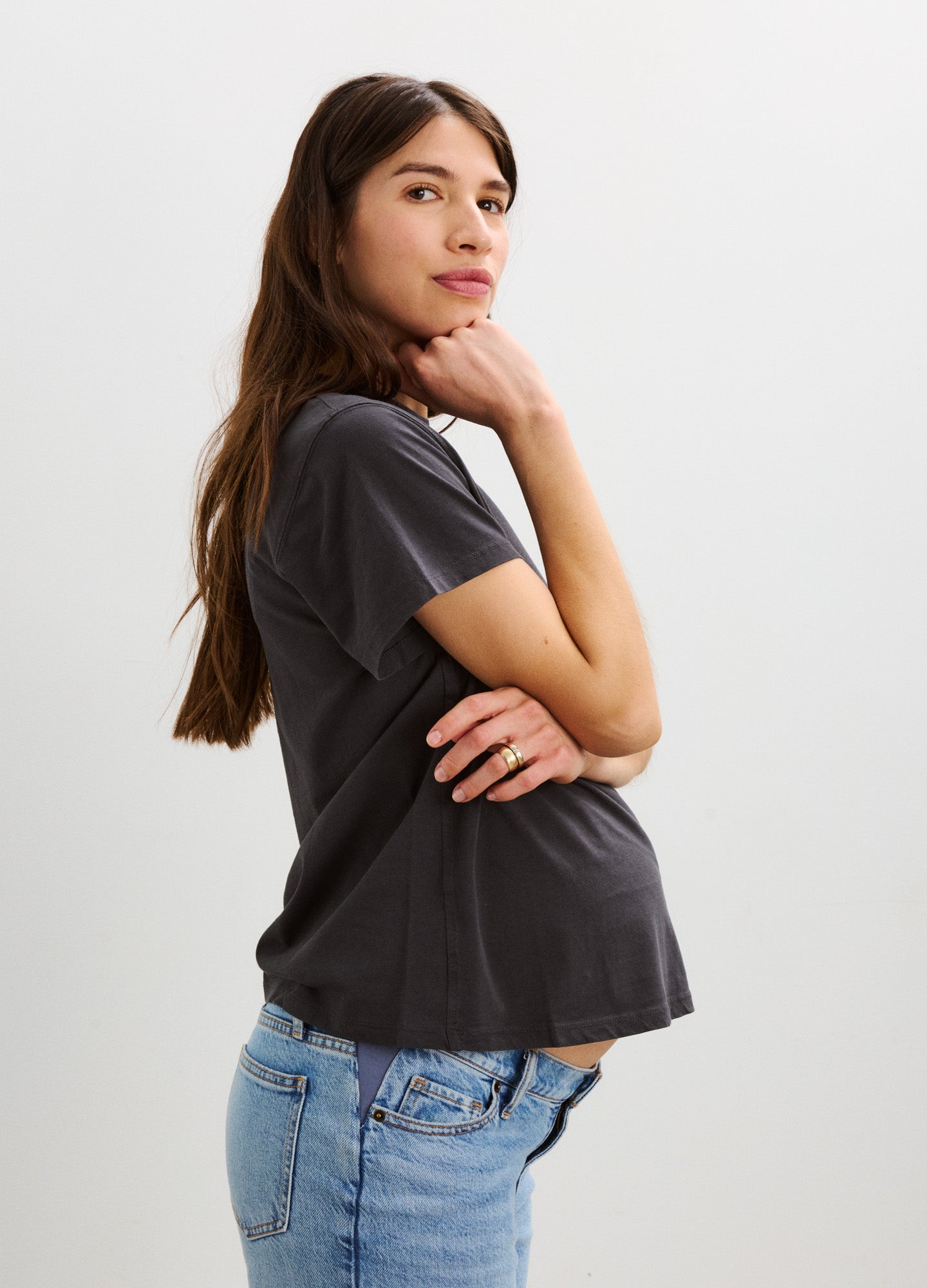 Maternity washed cotton crew neck T-shirt in black with short sleeves, relaxed fit over baby bump.