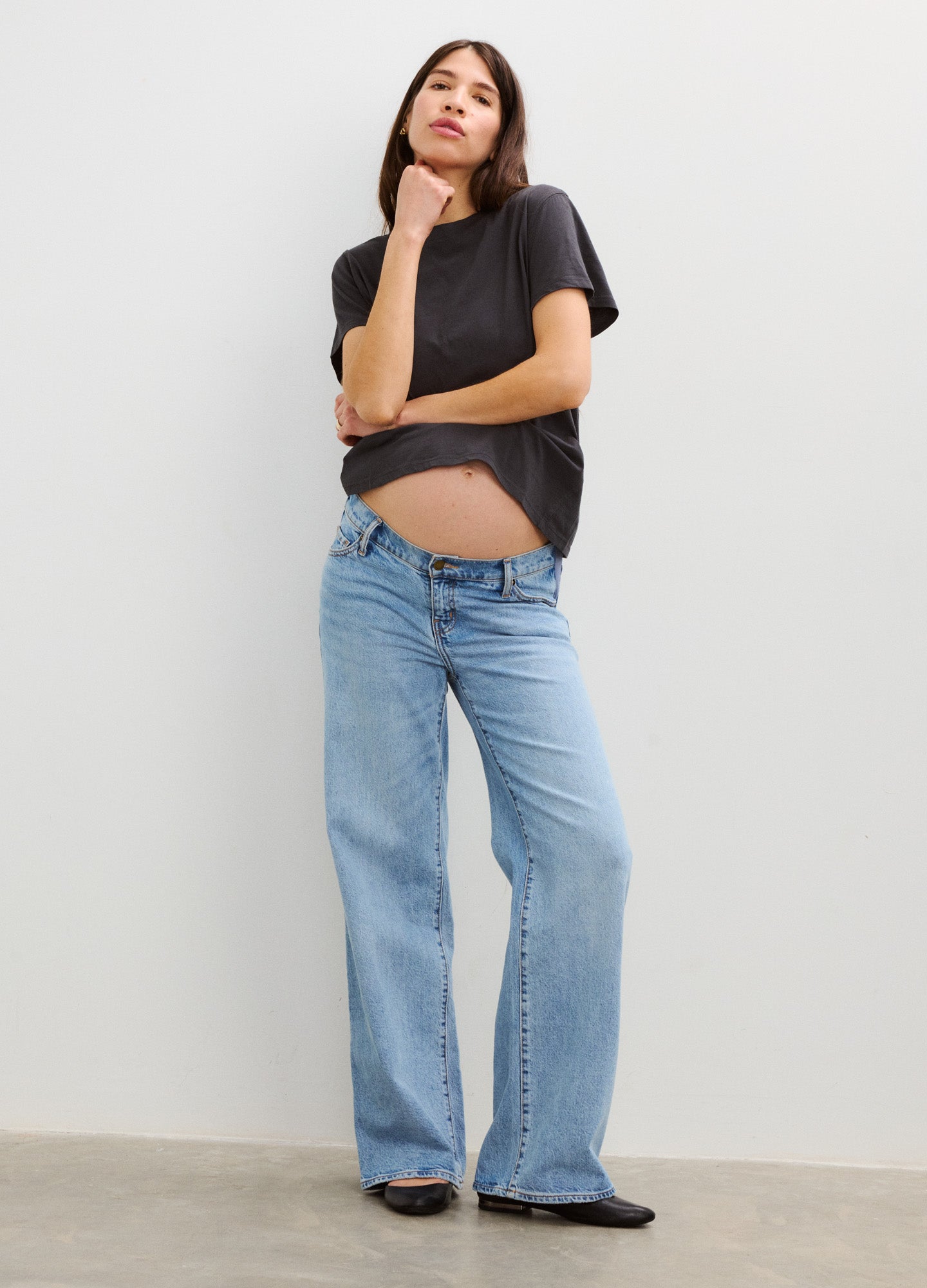 Light blue wide leg maternity jeans with a relaxed fit and full belly panel, styled with a black t-shirt.