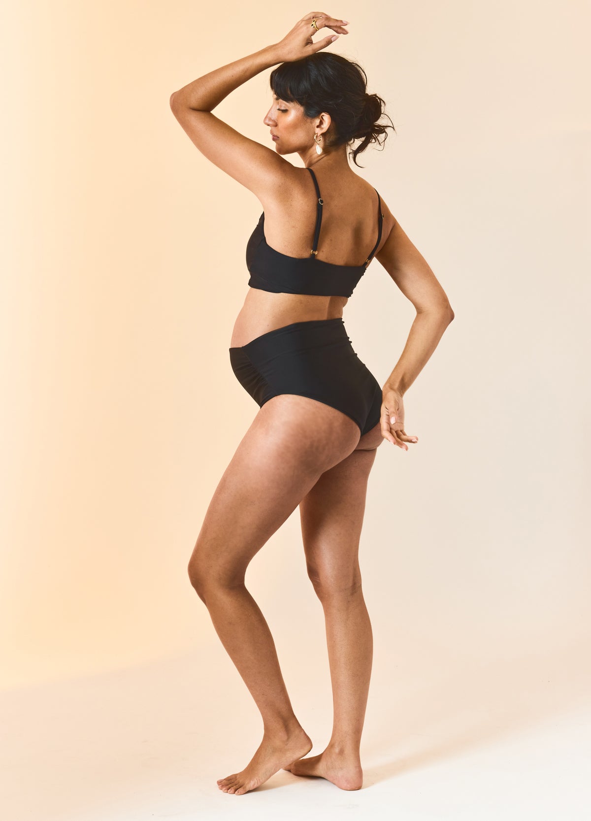 Black maternity bikini with supportive bandeau top and high-waisted bottom designed for pregnant women.