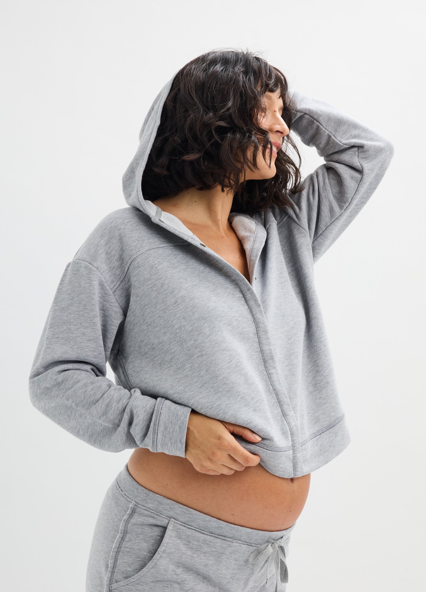 Light gray maternity hoodie with front zipper, relaxed fit, and soft fabric designed for nursing access.