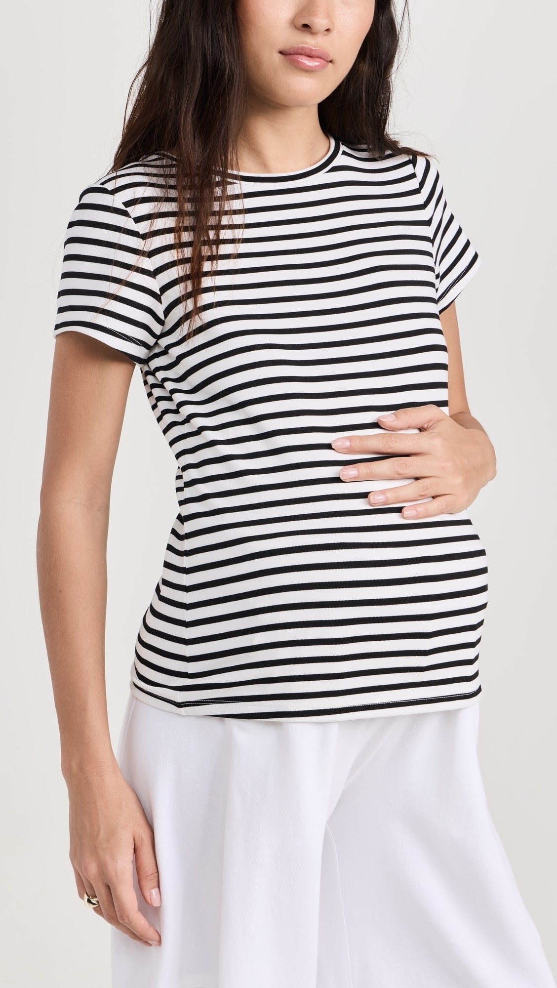 Black and white horizontal striped maternity crewneck t-shirt with short sleeves on pregnant model.