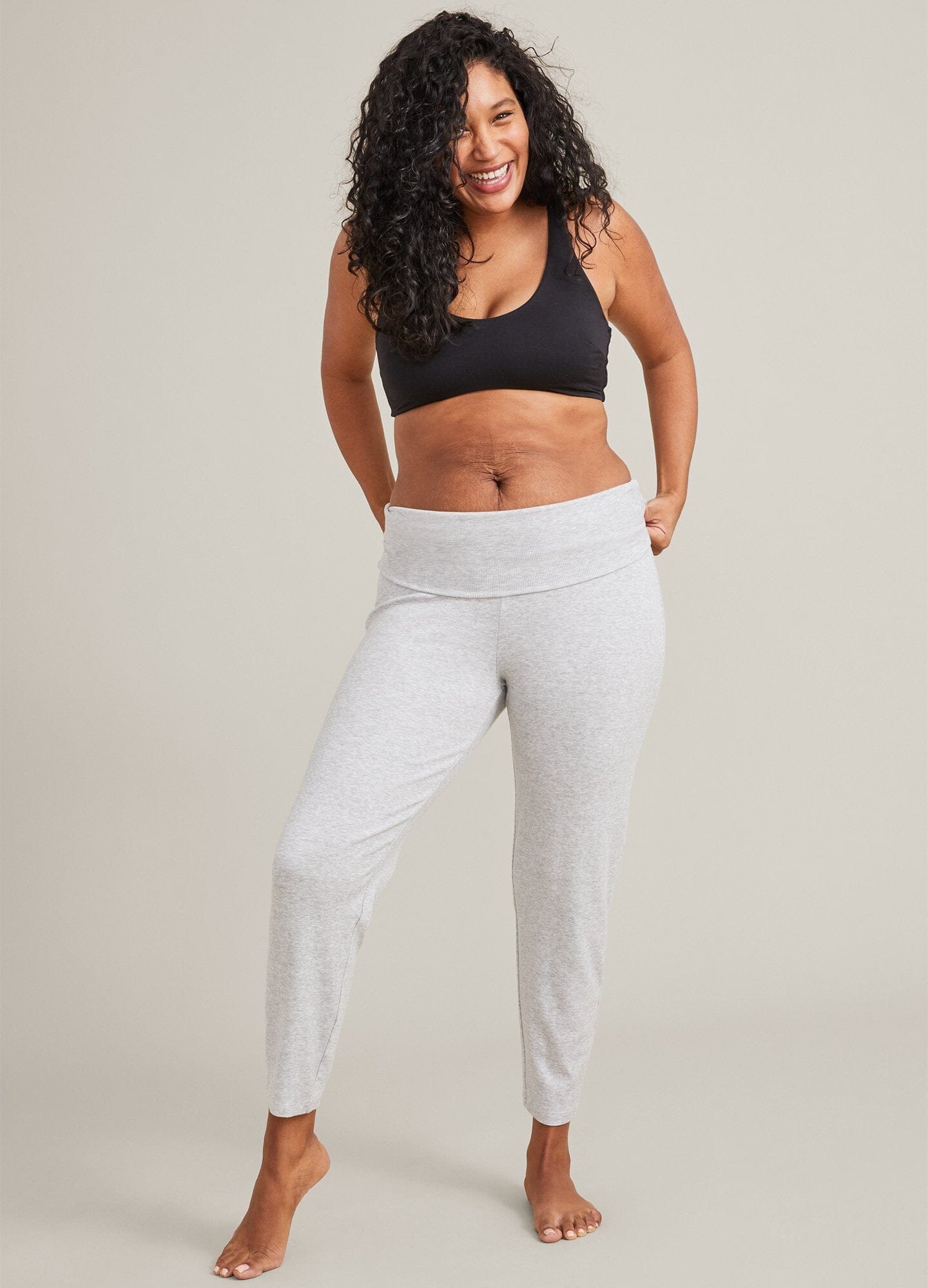 Black soft fabric maternity bra with wide straps and seamless cups modeled by woman.