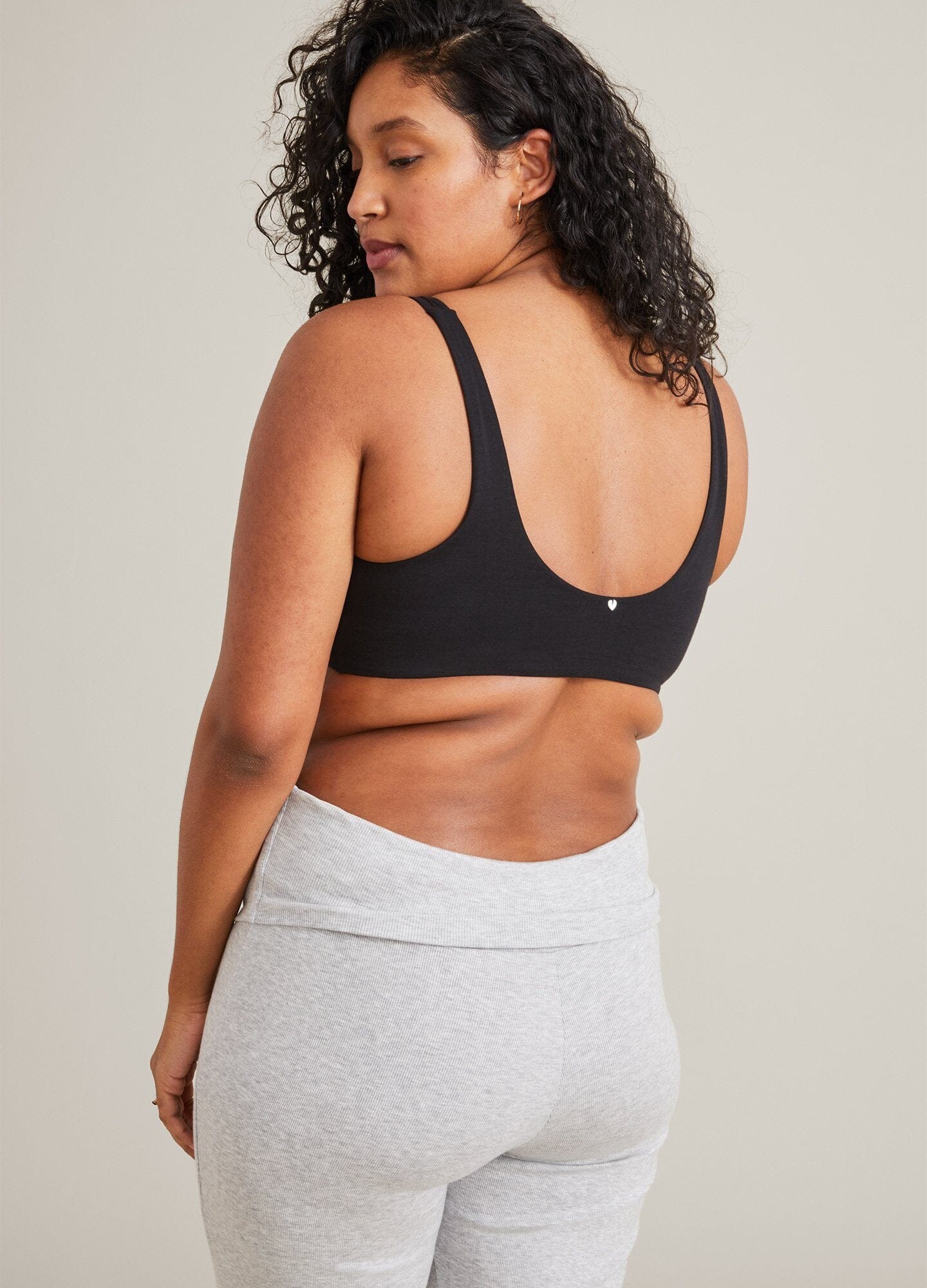 Black seamless maternity bra with wide adjustable straps and smooth back band.