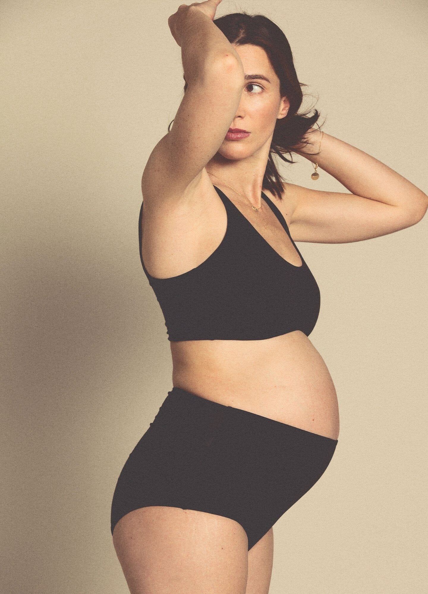 Black seamless maternity bra with wide straps and smooth, supportive fabric.