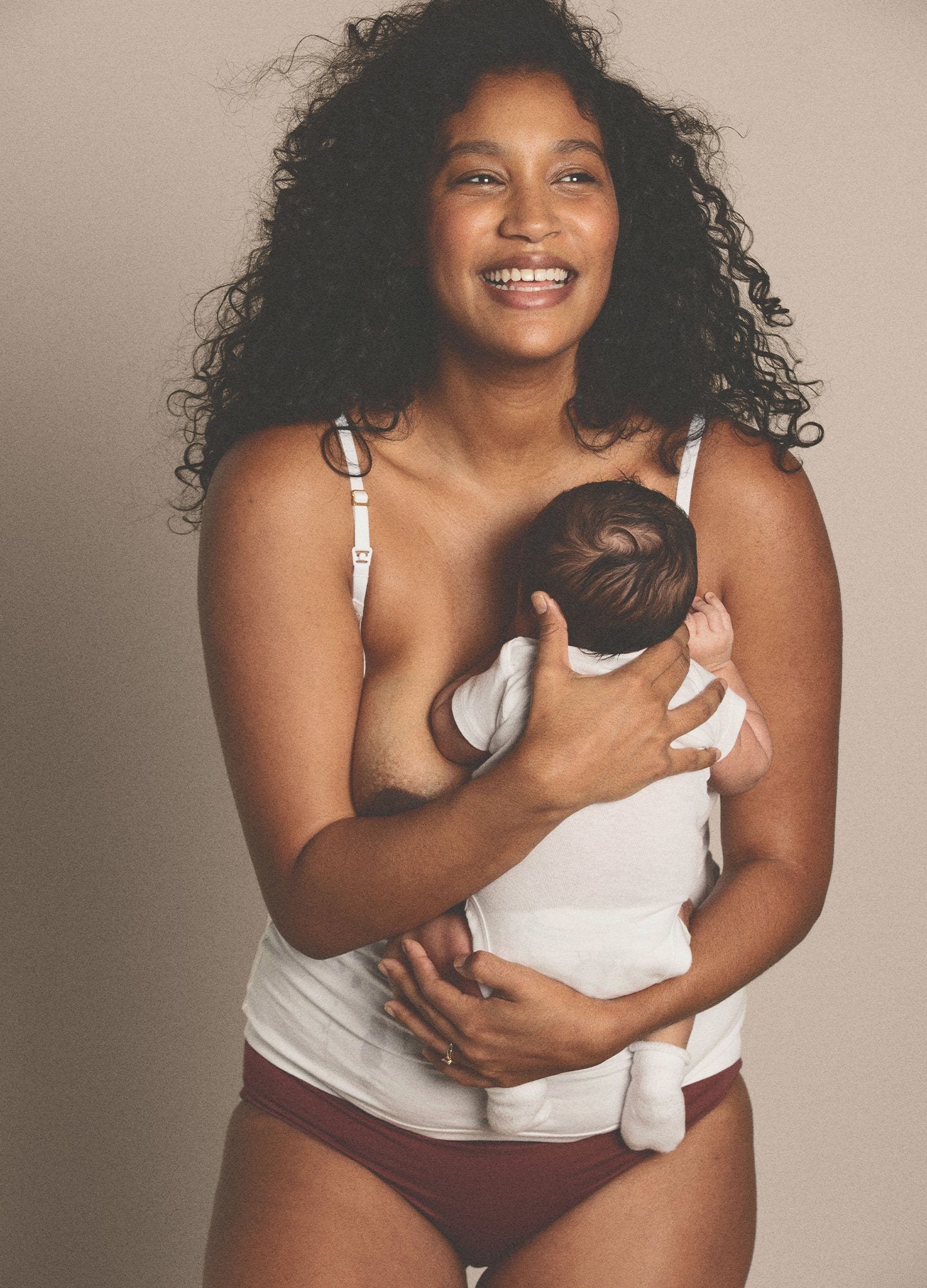 The 24/7 Nursing Tank POS - Buff-colored nursing tank with scoop neckline and slim straps, designed for maternity and postpartum wear.