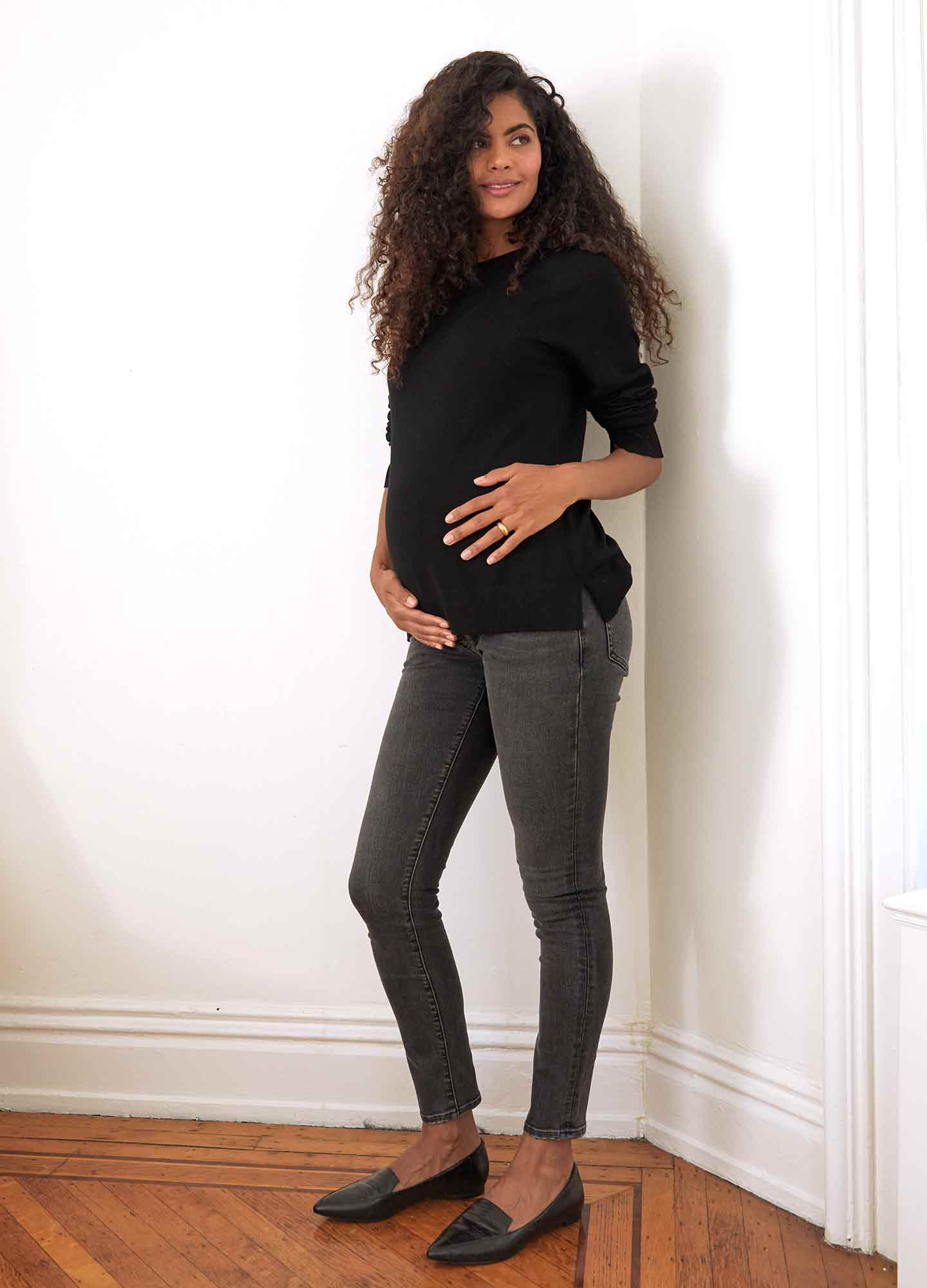 The Over The Bump Slim Maternity Jean - Slim black washed maternity jeans with over-the-bump fit, worn during pregnancy and postpartum.