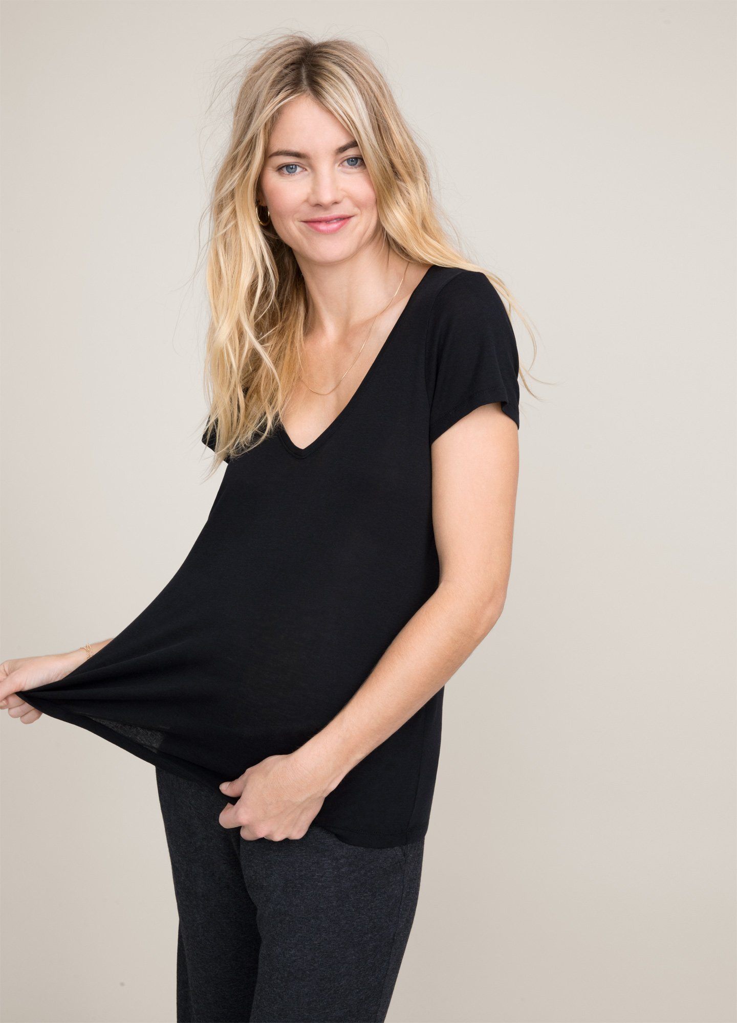 The Fitted Vee - Black fitted maternity tee with short sleeves and a V-neck, designed for pregnancy, nursing, and postpartum comfort.