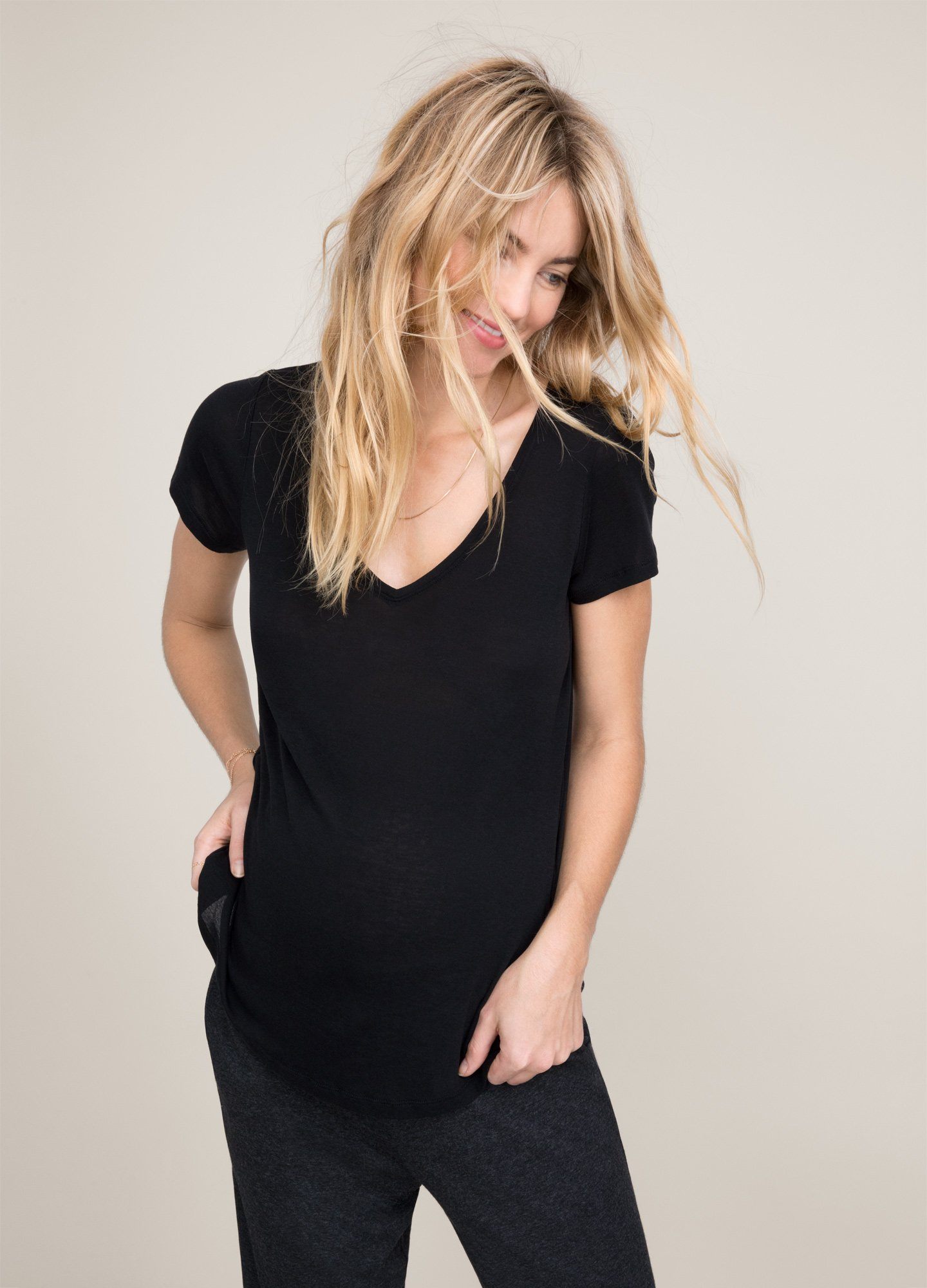 The Fitted Vee - Black fitted maternity tee with short sleeves and a V-neck, designed for pregnancy, nursing, and postpartum comfort.