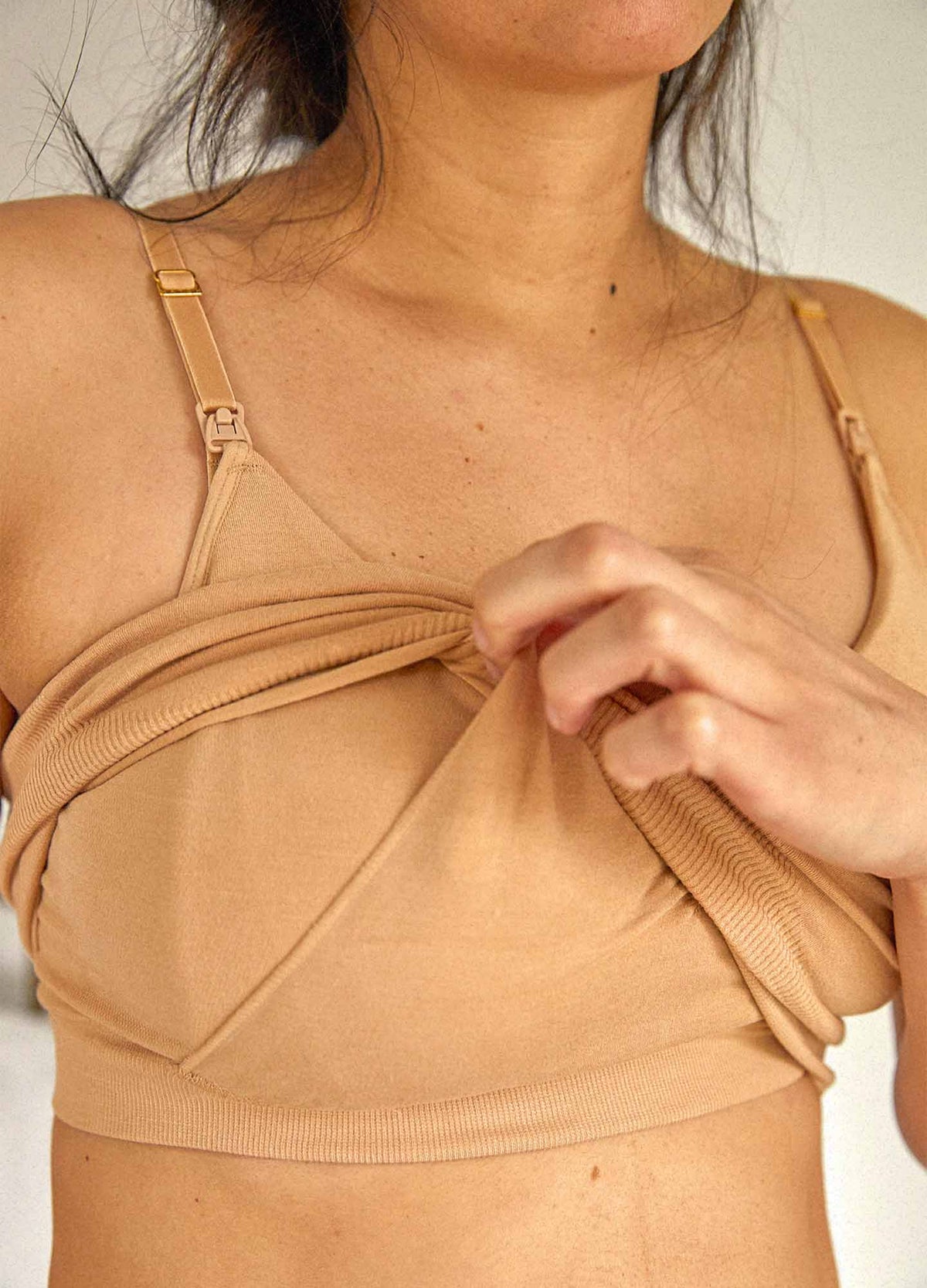 The Essential Nursing And Pumping Bra - Sand-colored maternity bra with adjustable straps designed for nursing and postpartum comfort.