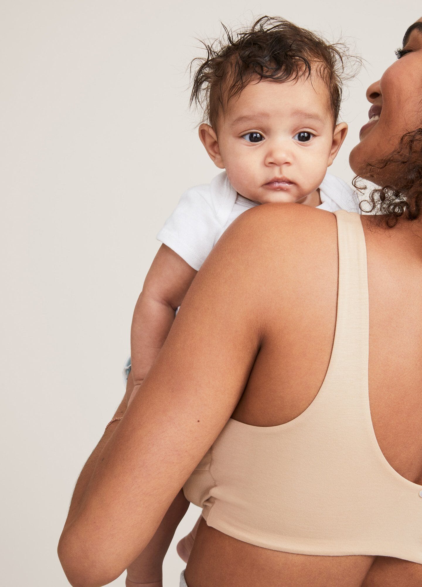 Nude maternity bra with wide straps and smooth, seamless design supporting postpartum comfort.