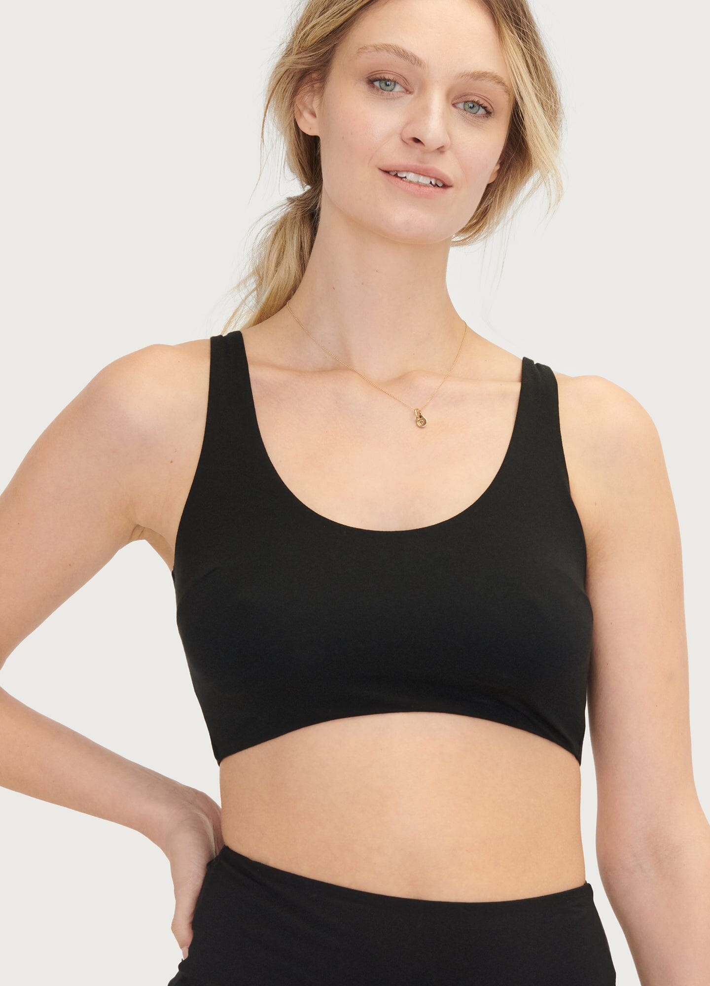 Black seamless maternity bra with wide straps and scoop neckline, soft stretch fabric.
