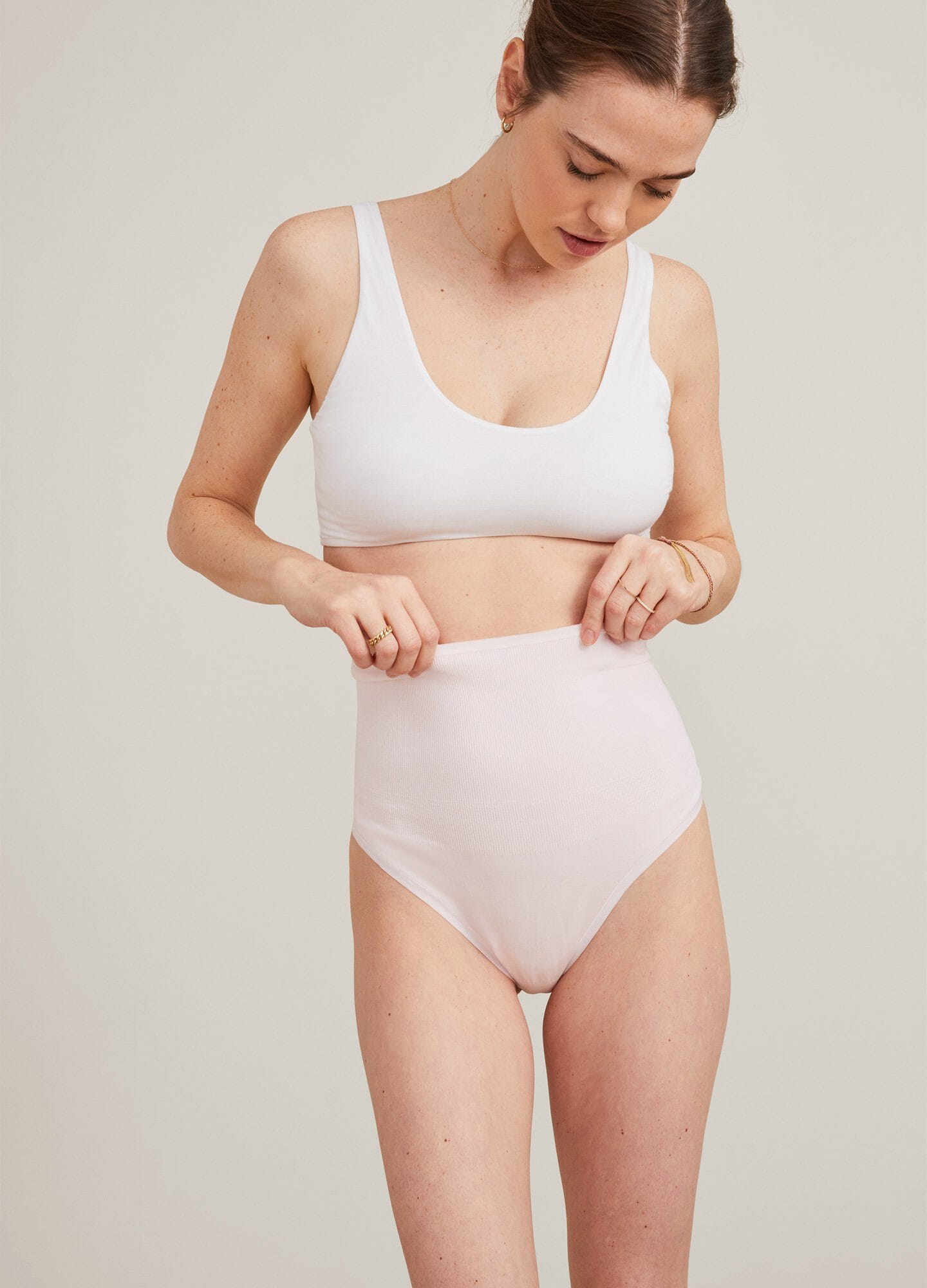 Soft, light pink high-waisted maternity briefs with a smooth, stretchy fabric and wide waistband.