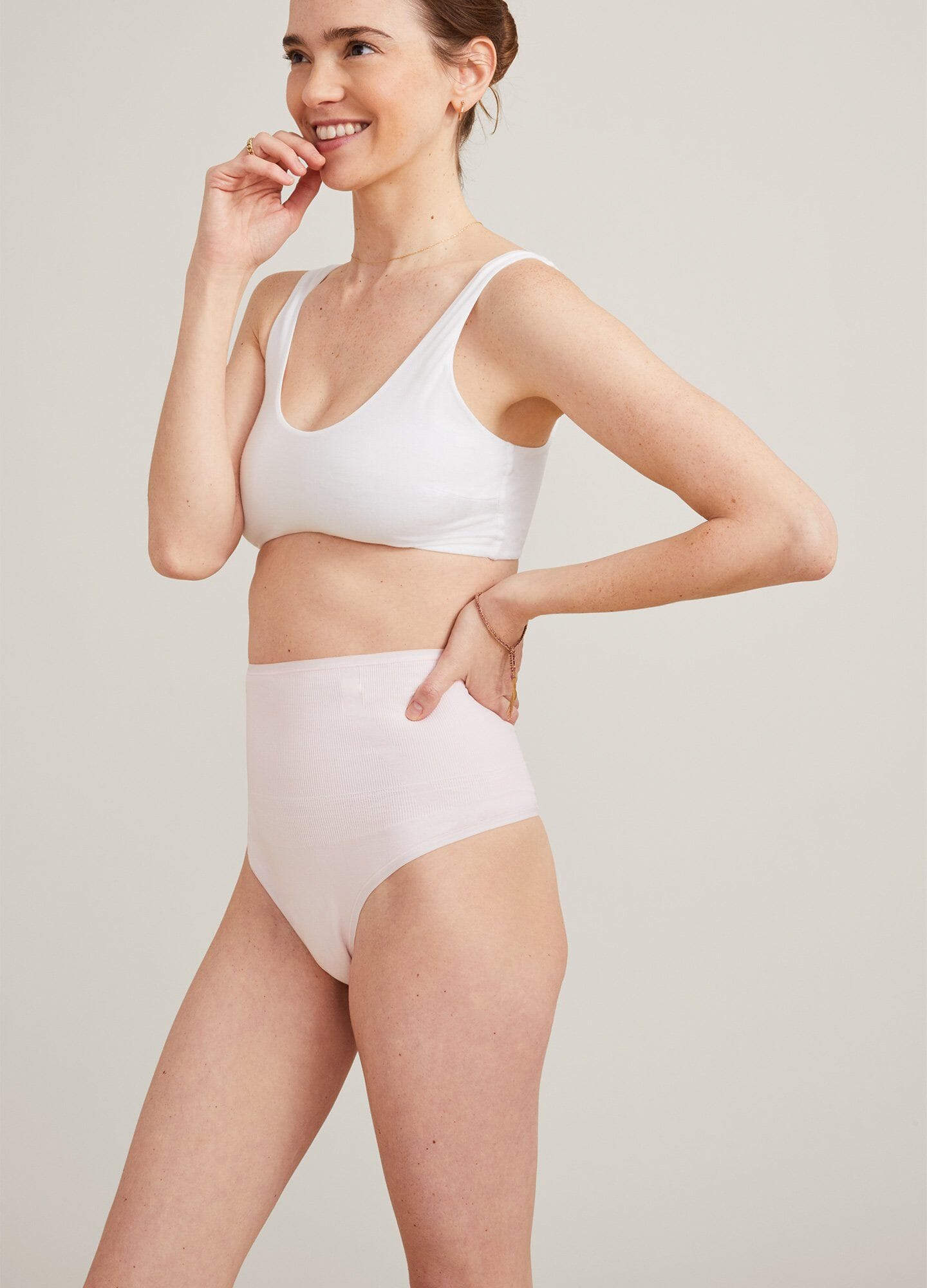Soft white maternity bra with wide straps and a seamless, supportive design.